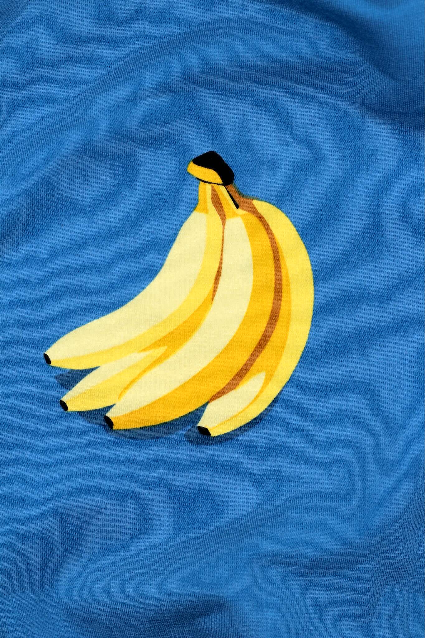 French-Terry-Stoff mit Banenen auf blauen Hintergrund